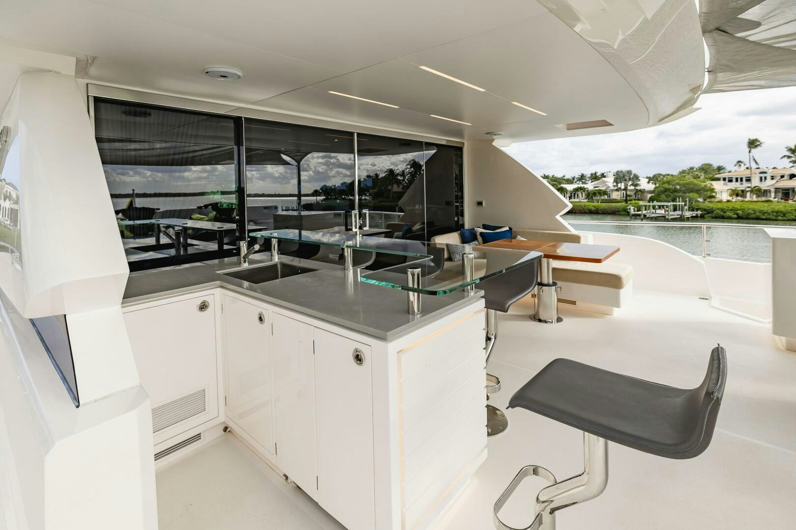 a room with a large window and a table with chairs and a large window aboard AQUA LIFE Yacht for Sale