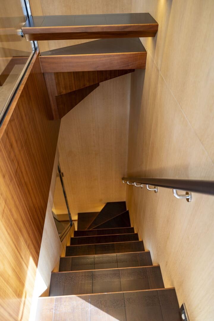 a wooden staircase with a wood railing aboard AQUA LIFE Yacht for Sale