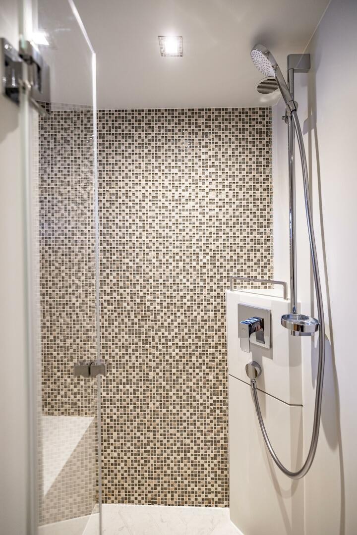 a shower with a tile wall aboard AQUA LIFE Yacht for Sale