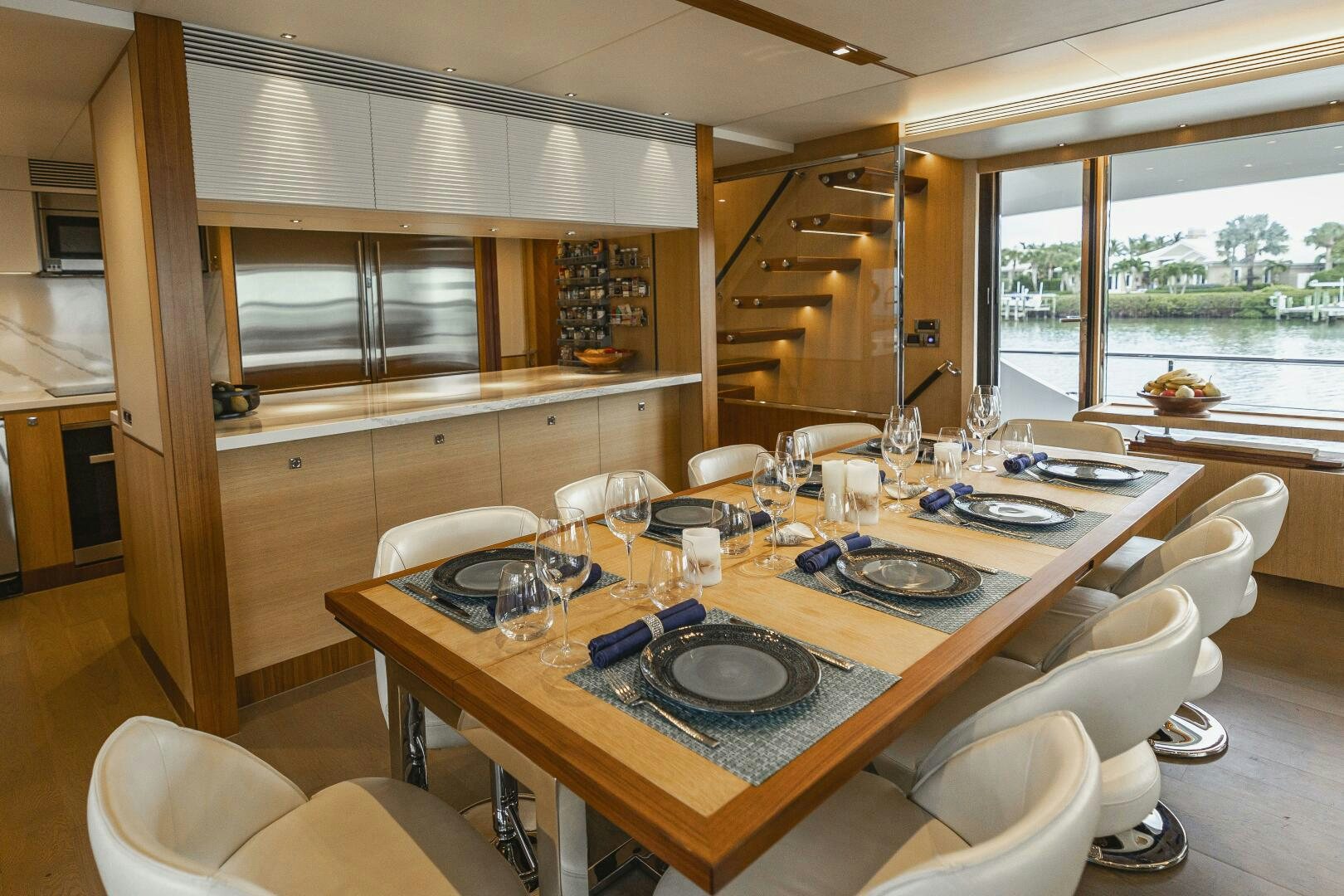 a dining table with plates and chairs aboard AQUA LIFE Yacht for Sale
