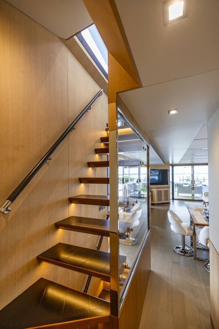 a wooden staircase in a house aboard AQUA LIFE Yacht for Sale