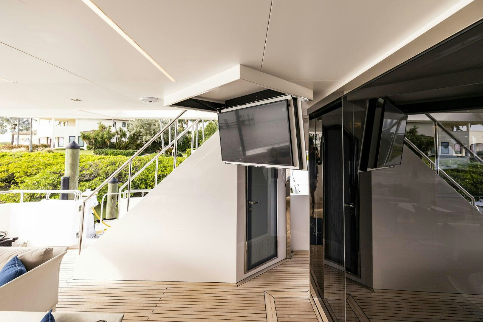 a room with a tv and a balcony aboard AQUA LIFE Yacht for Sale