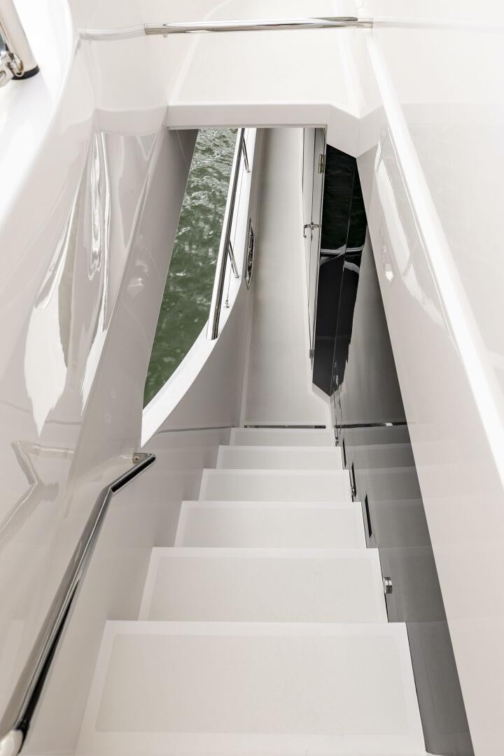 a white staircase with a railing aboard AQUA LIFE Yacht for Sale