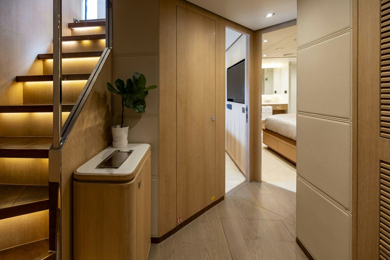 a room with a wood floor and a plant on the wall aboard AQUA LIFE Yacht for Sale