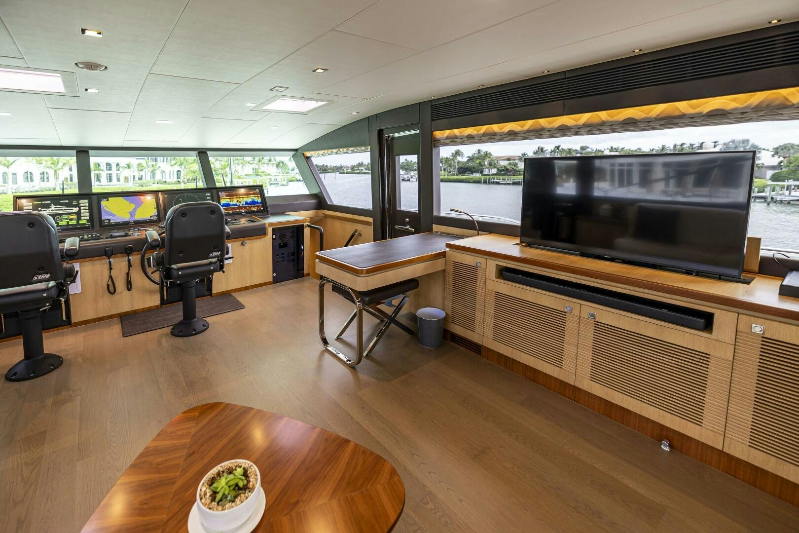 a room with a table and chairs and a tv aboard AQUA LIFE Yacht for Sale