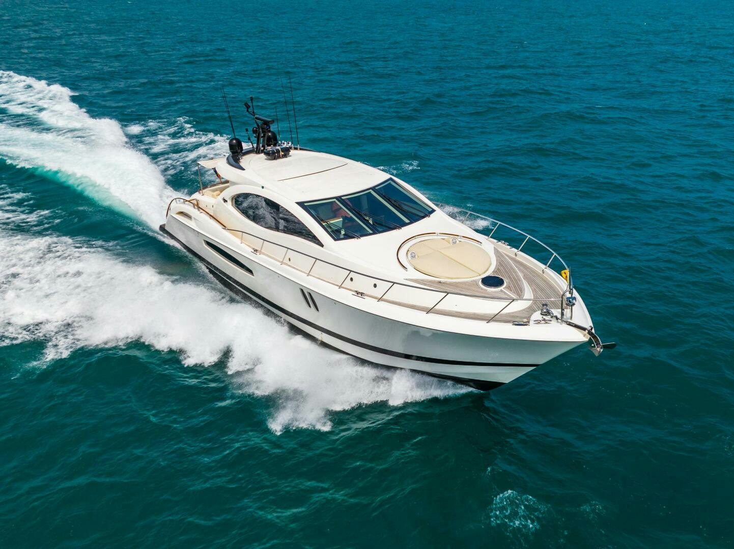 a white boat on the water aboard COMMITTED Yacht for Sale