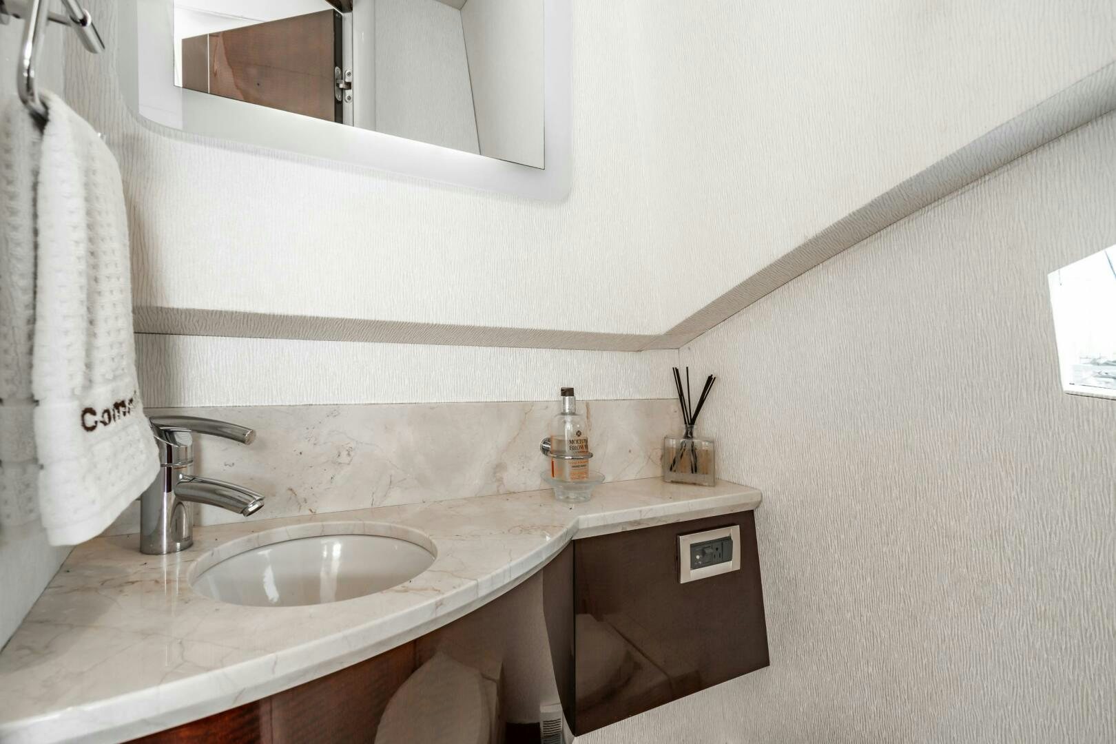 a bathroom with a sink and a mirror aboard COMMITTED Yacht for Sale