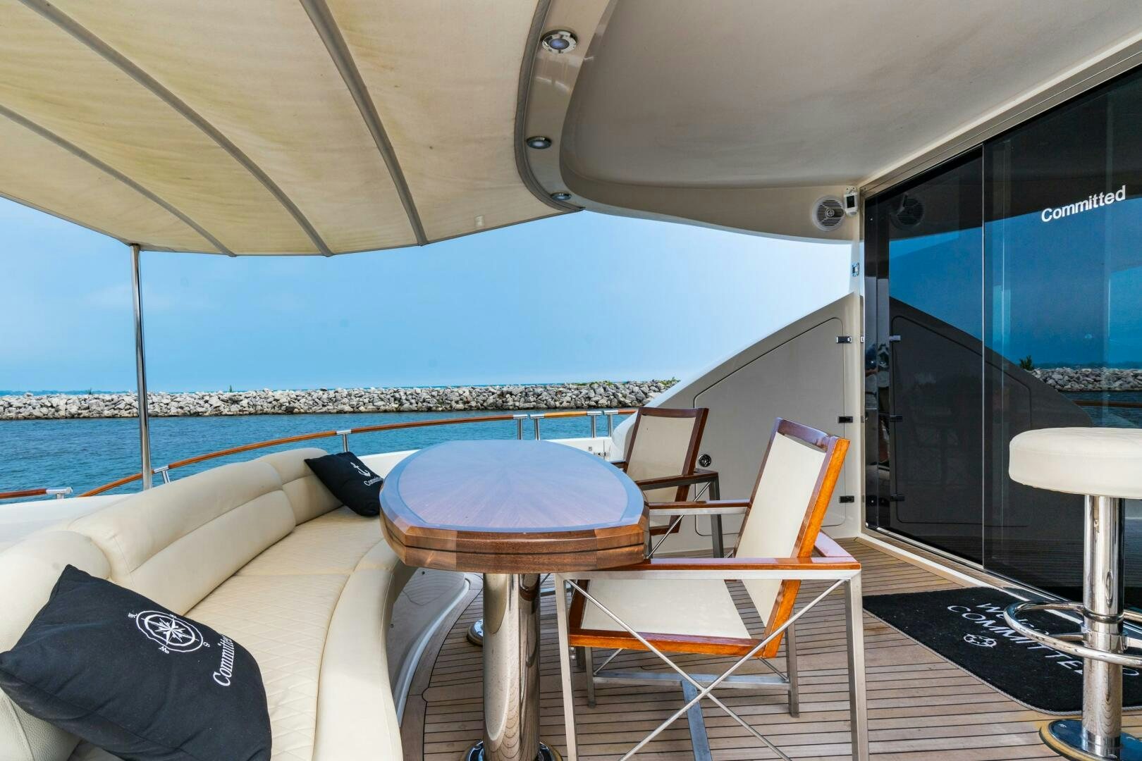 a boat with a table and chairs aboard COMMITTED Yacht for Sale