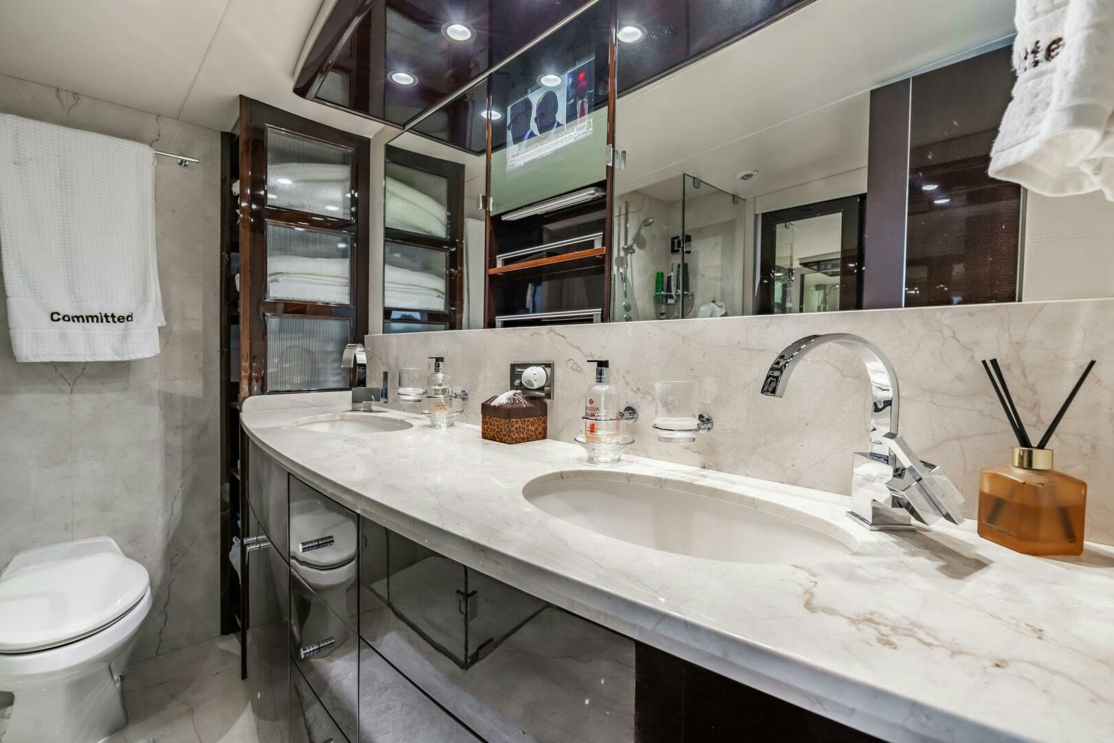 a bathroom with a large mirror aboard COMMITTED Yacht for Sale
