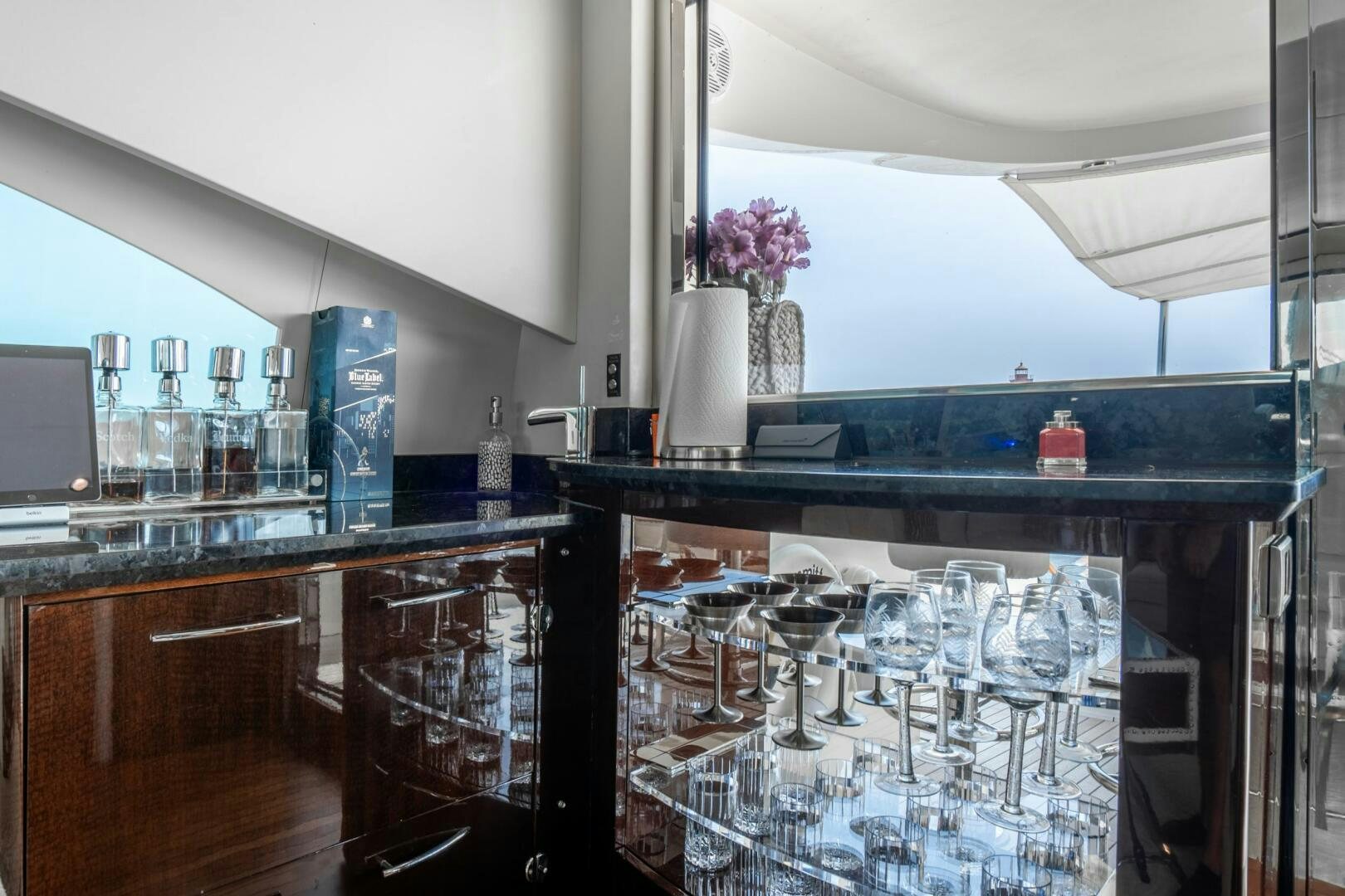 a kitchen with a bar and cabinets aboard COMMITTED Yacht for Sale