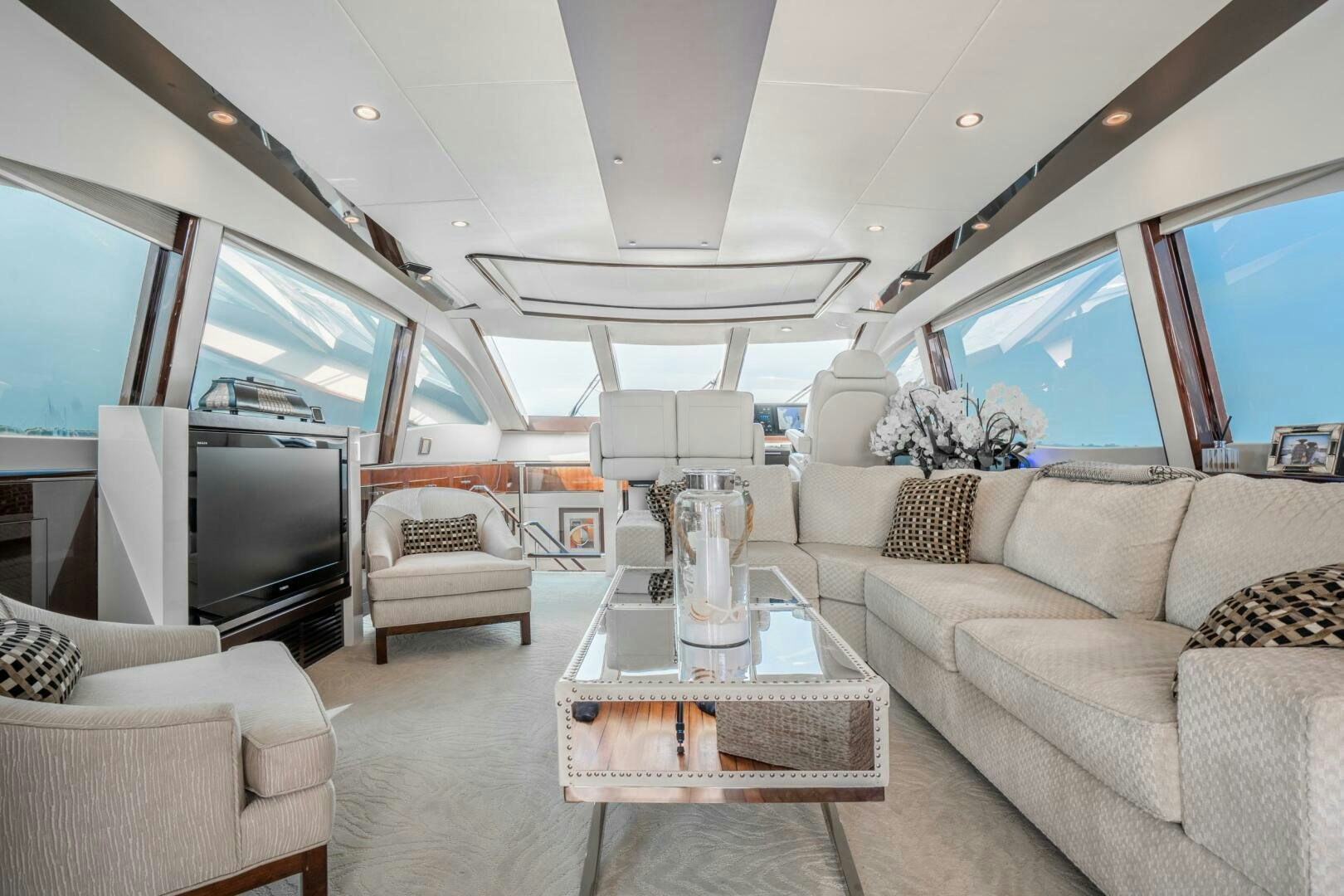 a living room with a couch and a television aboard COMMITTED Yacht for Sale