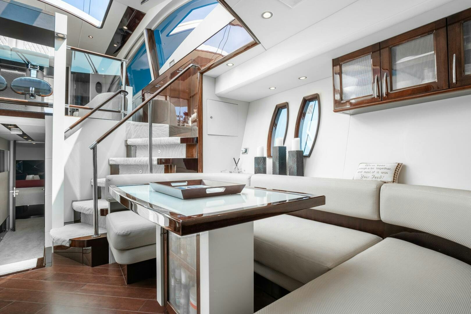 a room with a table and couch aboard COMMITTED Yacht for Sale