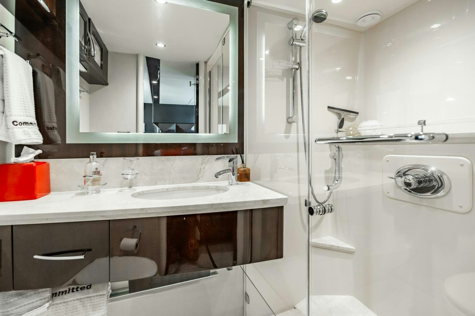 a bathroom with a sink and a mirror aboard COMMITTED Yacht for Sale