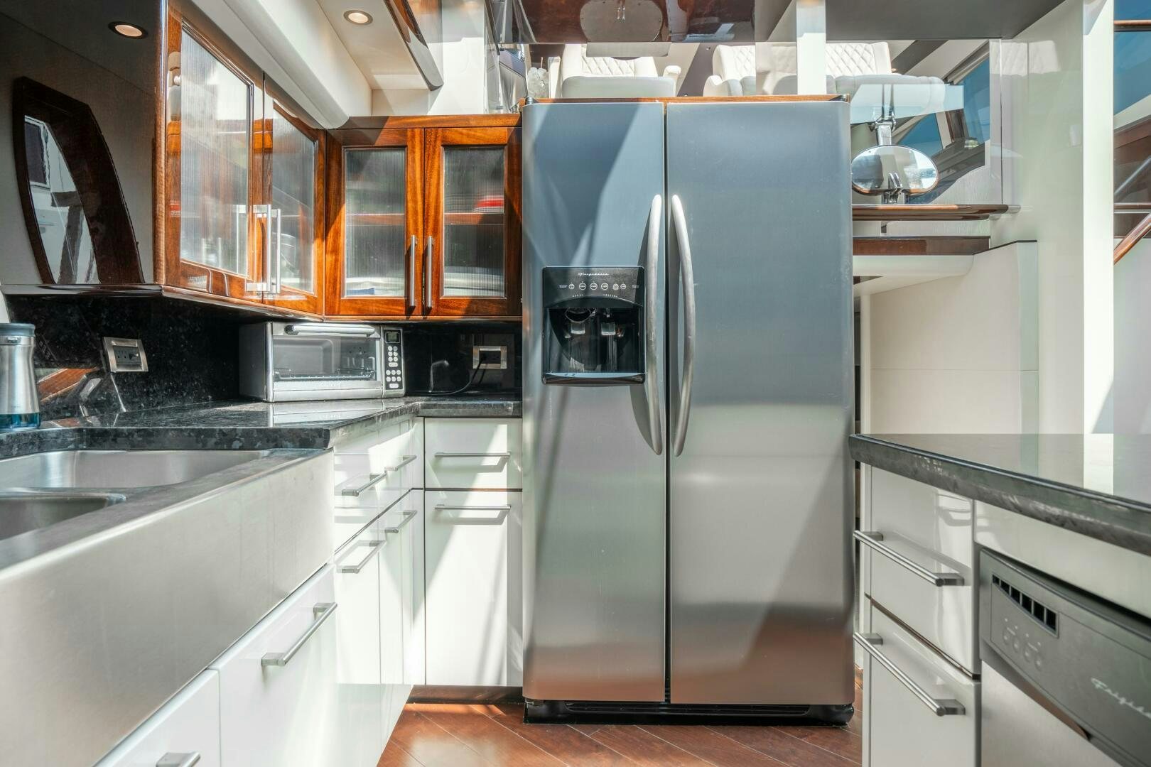 a kitchen with a stainless steel refrigerator aboard COMMITTED Yacht for Sale
