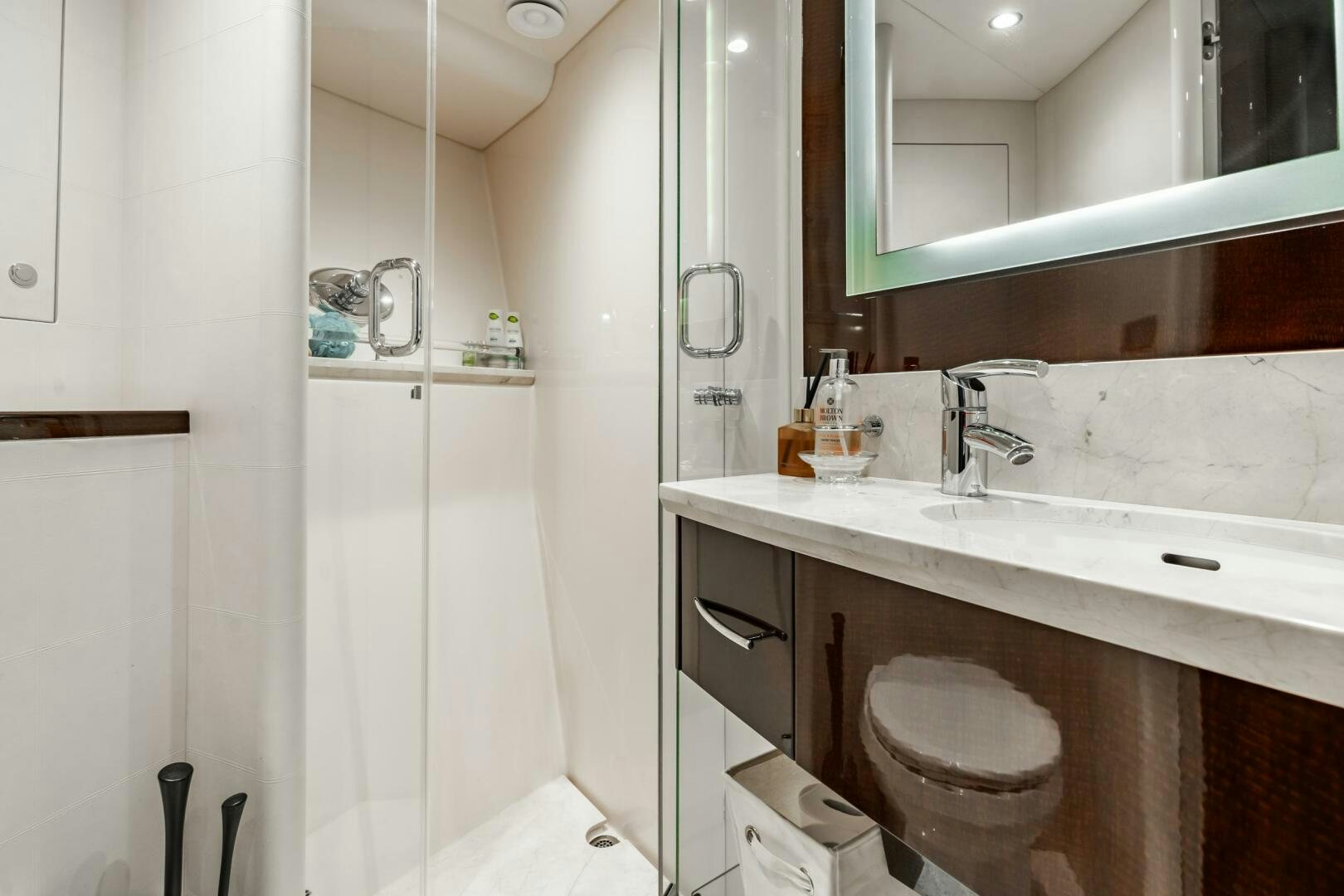 a bathroom with a sink and a mirror aboard COMMITTED Yacht for Sale