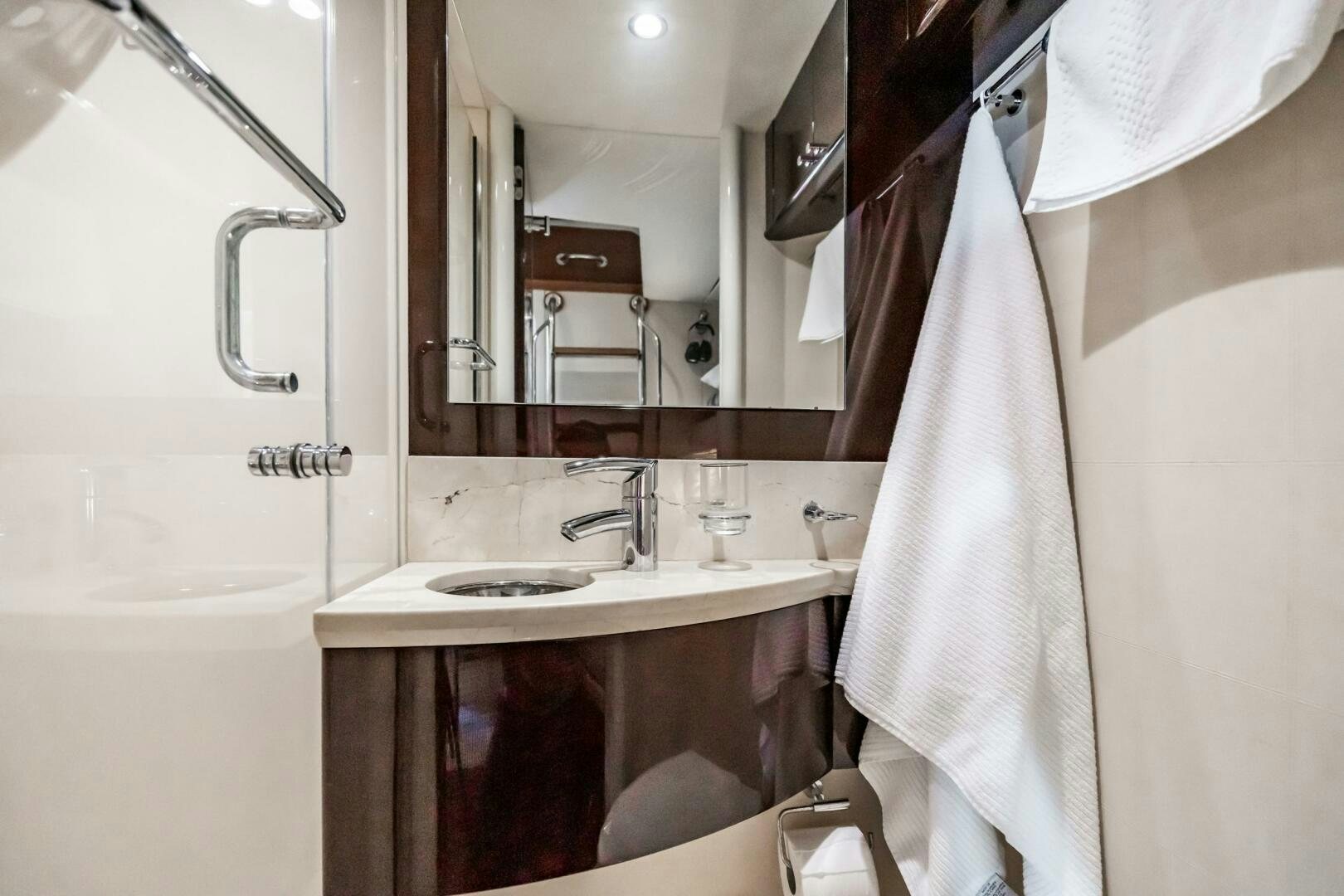 a bathroom with a sink and a mirror aboard COMMITTED Yacht for Sale
