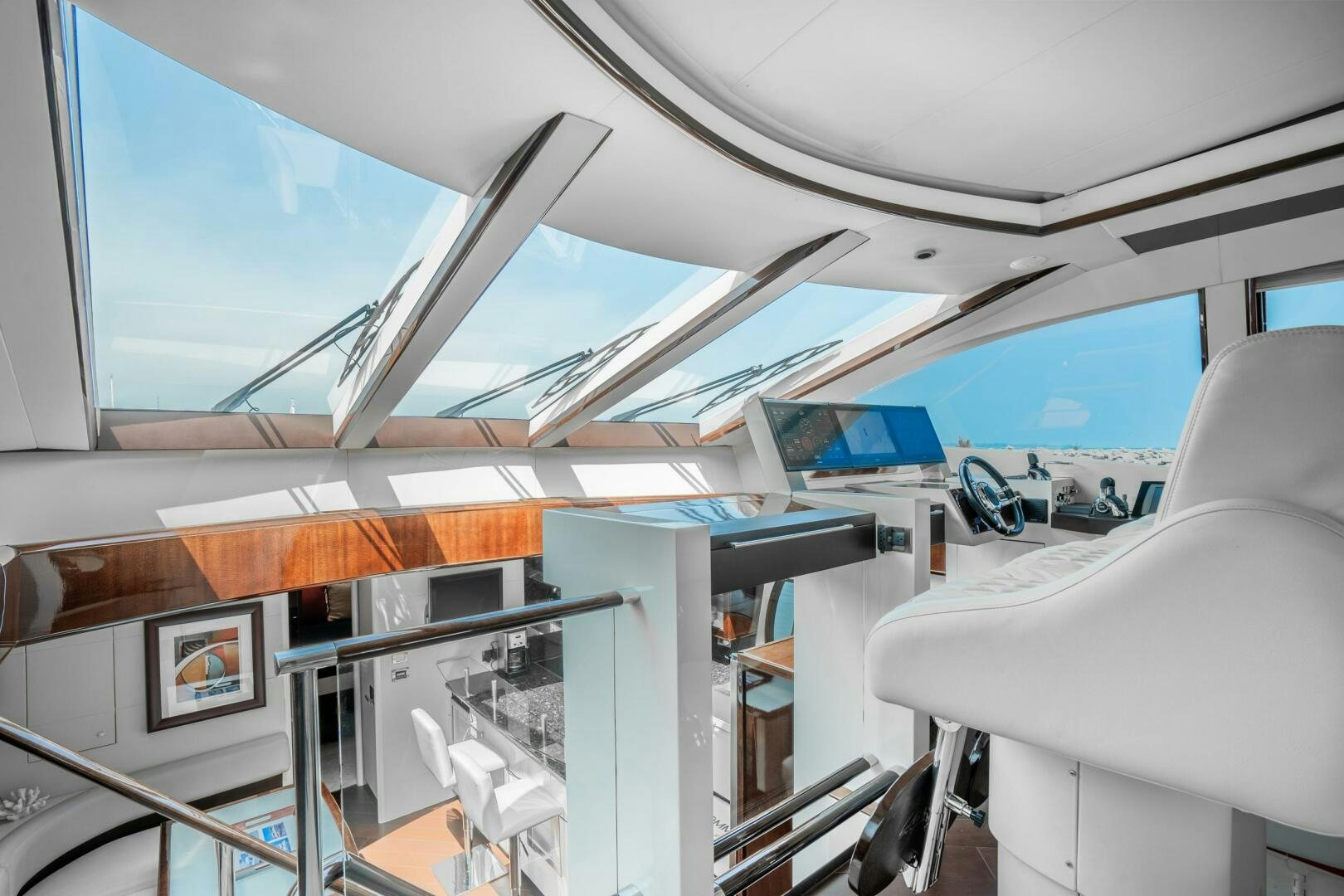 a room with a large window and a white couch aboard COMMITTED Yacht for Sale