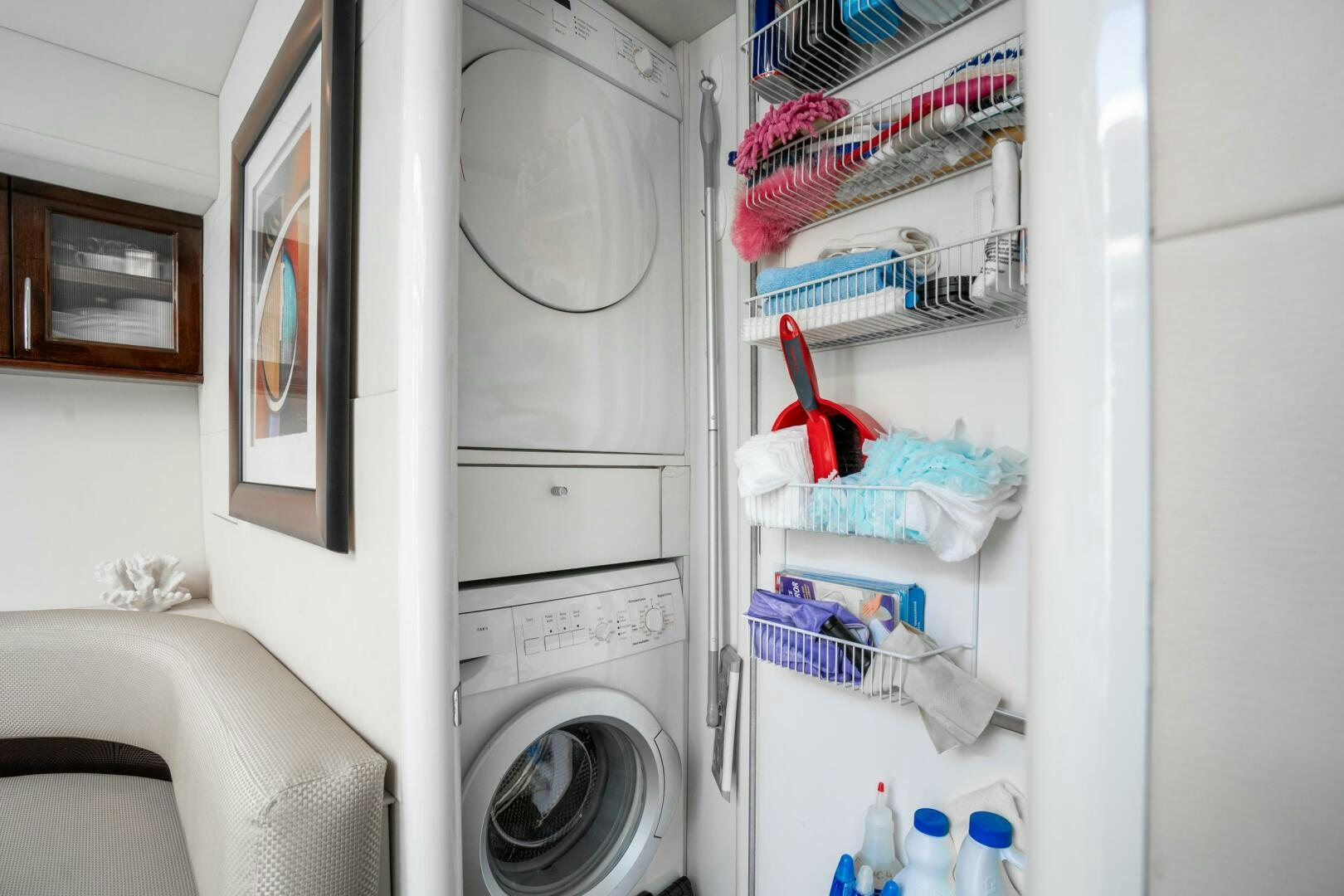 a white room with a white dryer and a white wall aboard COMMITTED Yacht for Sale