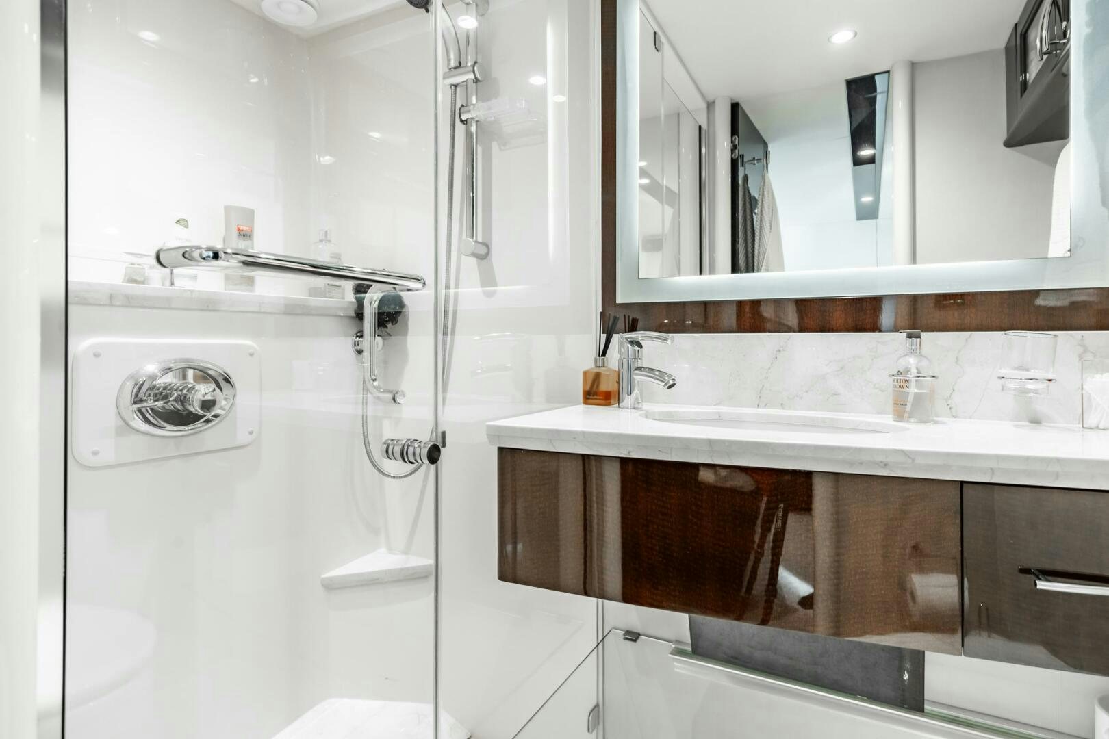 a bathroom with a sink and a mirror aboard COMMITTED Yacht for Sale