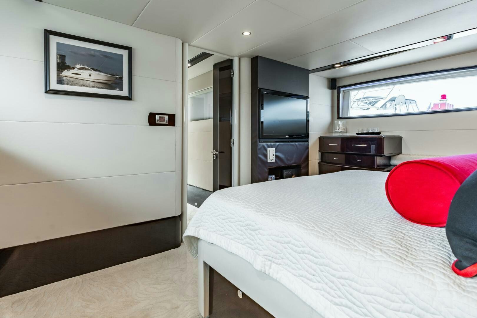 a bedroom with a bed and a television aboard COMMITTED Yacht for Sale