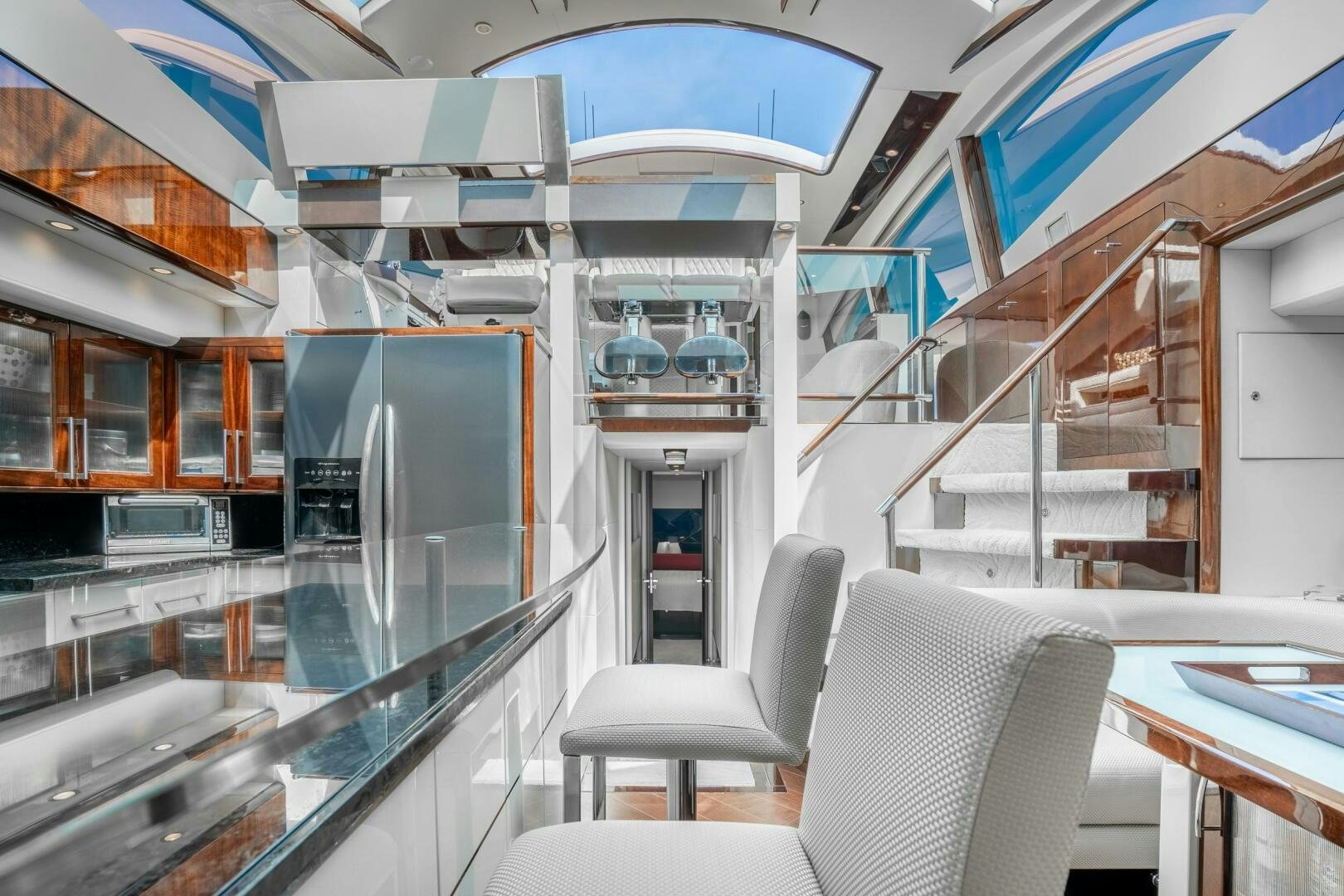 a room with a glass wall and a staircase aboard COMMITTED Yacht for Sale