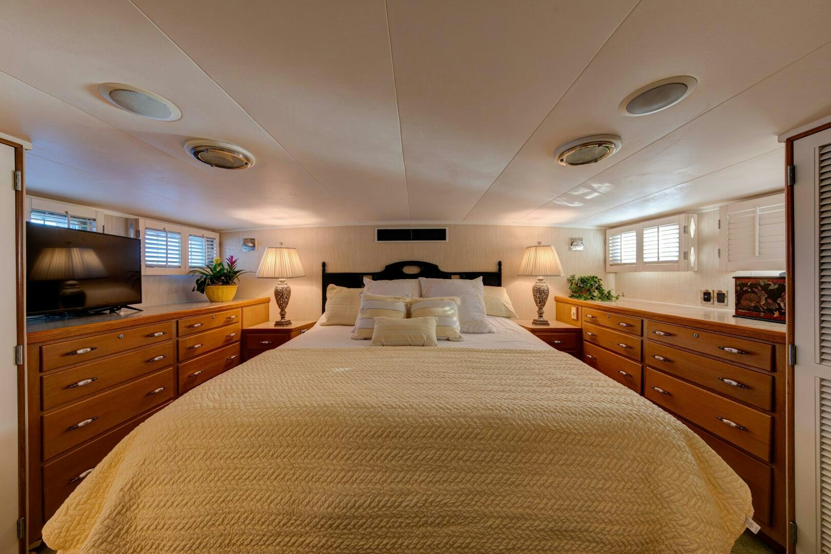 a large bedroom with a large bed aboard KOALA Yacht for Sale