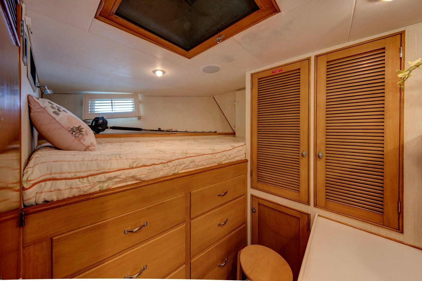 a bedroom with a bed and cabinets aboard KOALA Yacht for Sale