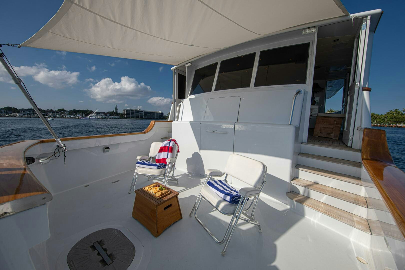 a white boat with chairs and a table on a deck aboard KOALA Yacht for Sale
