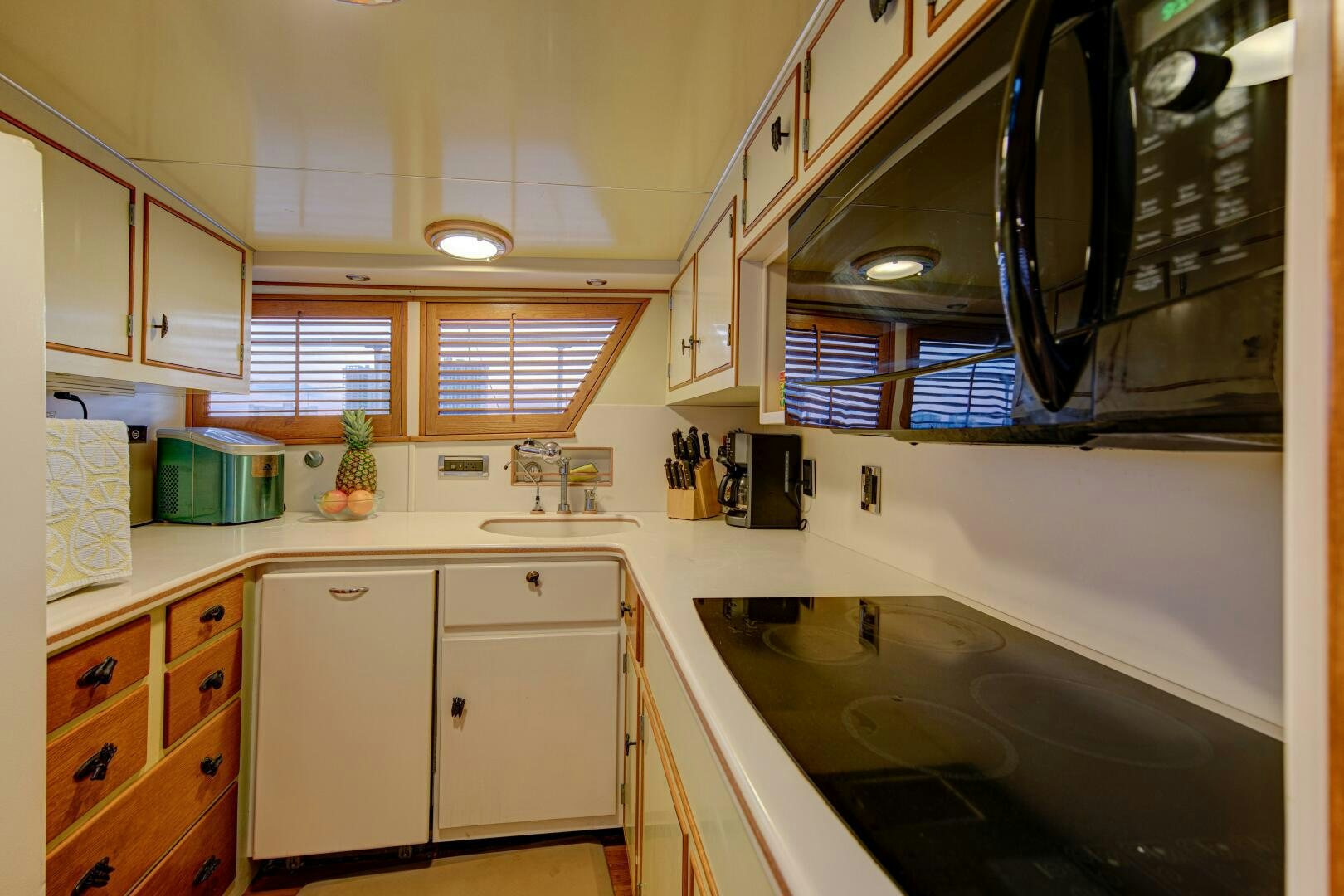 a kitchen with white cabinets aboard KOALA Yacht for Sale