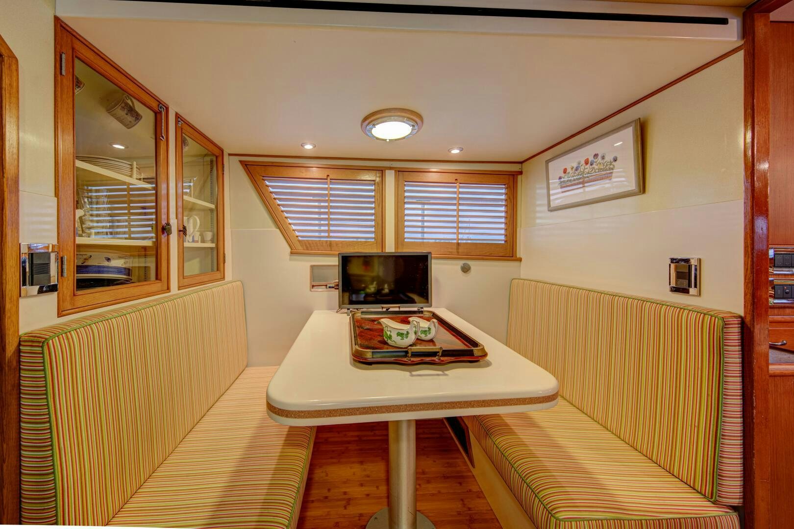 a room with a table and a bed aboard KOALA Yacht for Sale