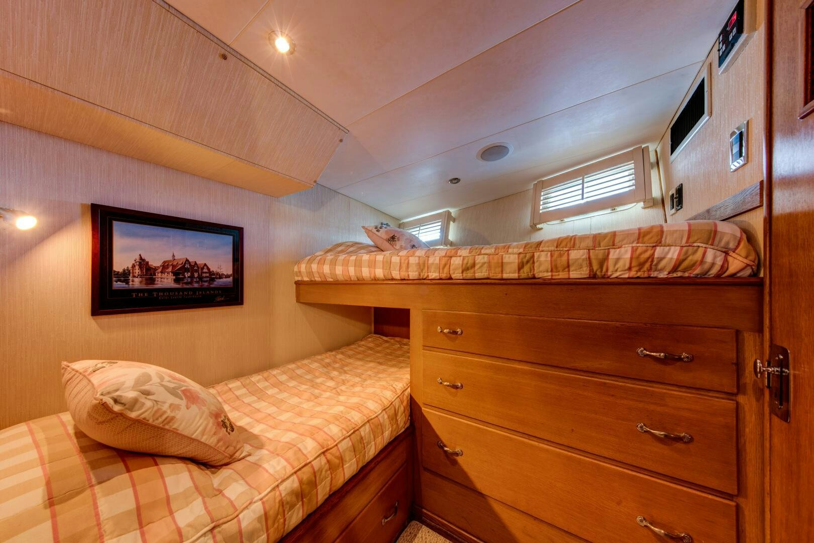 a bedroom with a bed and a dresser aboard KOALA Yacht for Sale