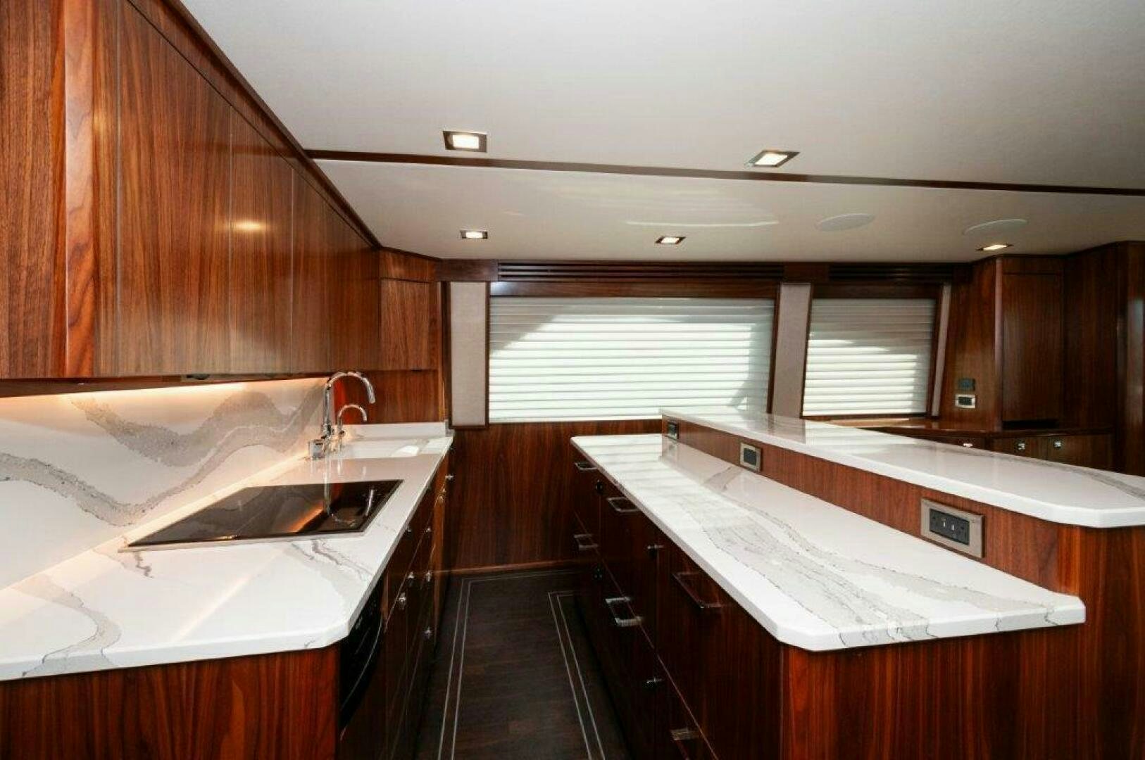 a kitchen with wooden cabinets aboard FLEUR DE LIS Yacht for Sale