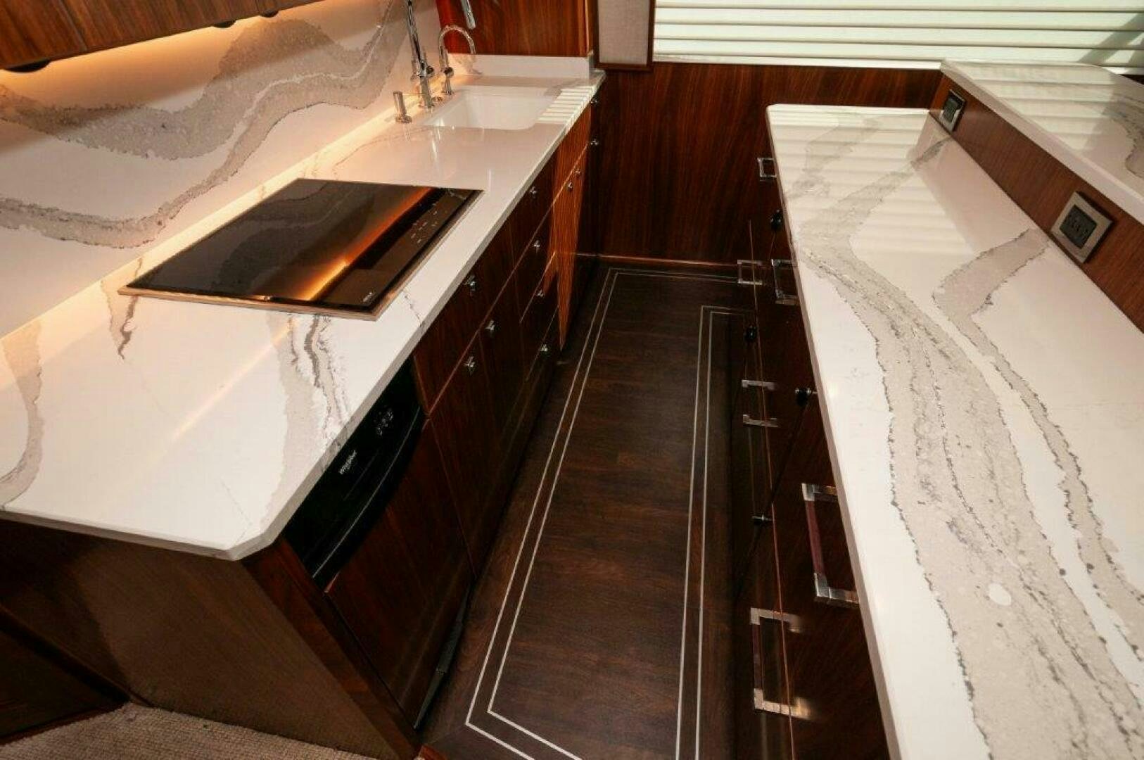 a kitchen with a sink and a microwave aboard FLEUR DE LIS Yacht for Sale