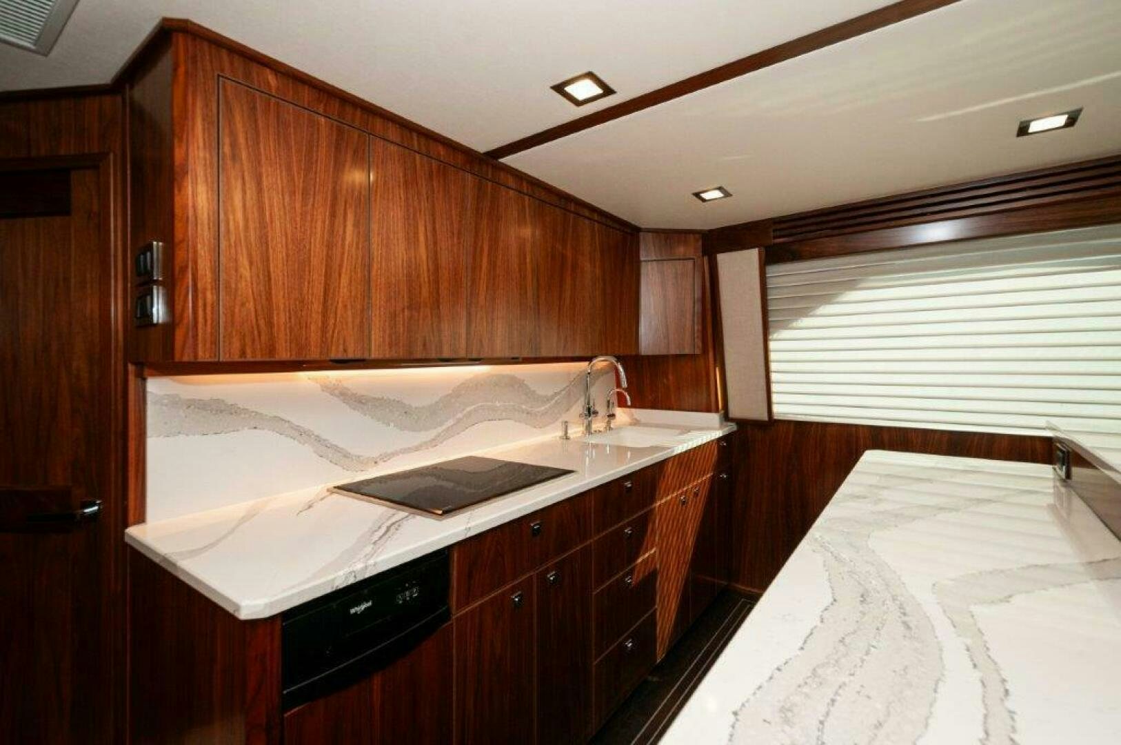 a kitchen with wooden cabinets aboard FLEUR DE LIS Yacht for Sale