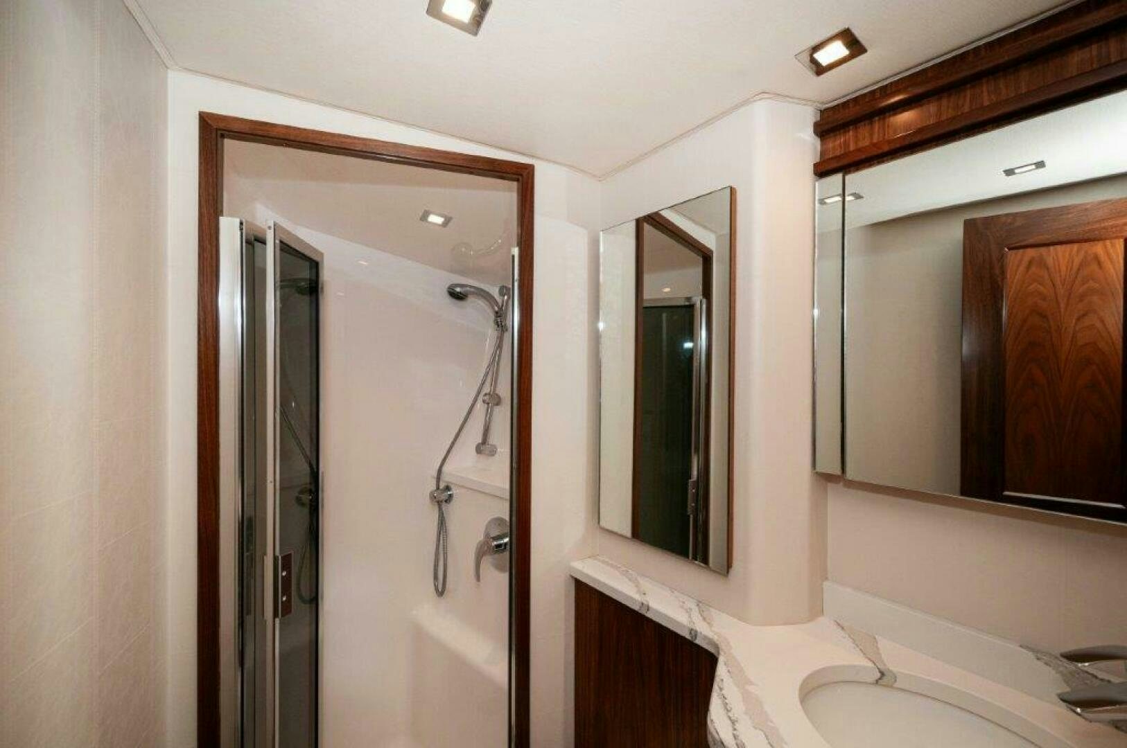 a bathroom with a large mirror aboard FLEUR DE LIS Yacht for Sale