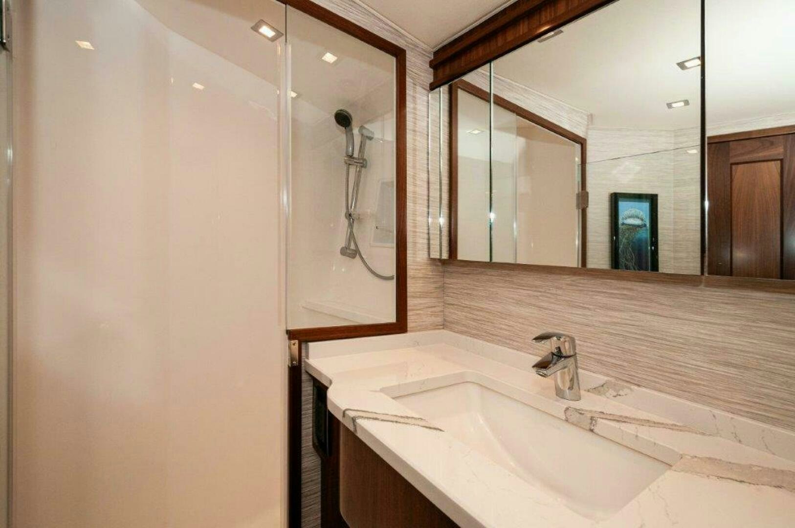 a bathroom with a large mirror aboard FLEUR DE LIS Yacht for Sale