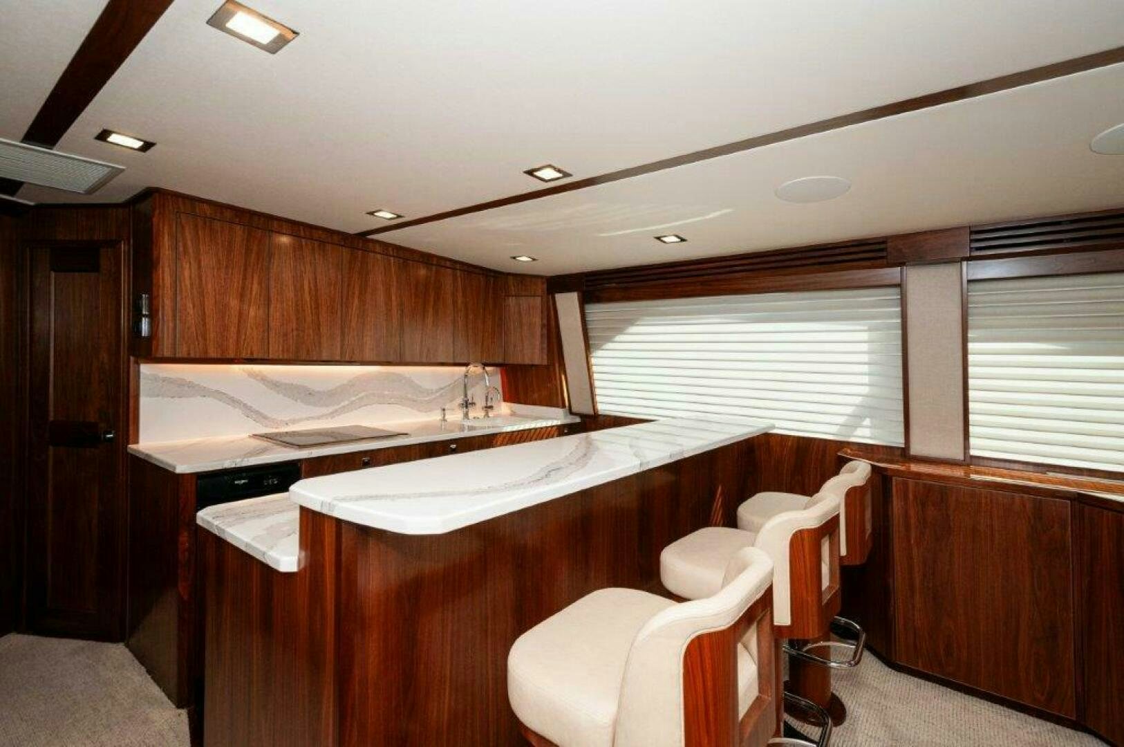 a room with a desk and chairs aboard FLEUR DE LIS Yacht for Sale