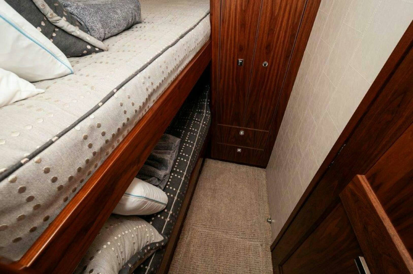 a bed with a black frame aboard FLEUR DE LIS Yacht for Sale