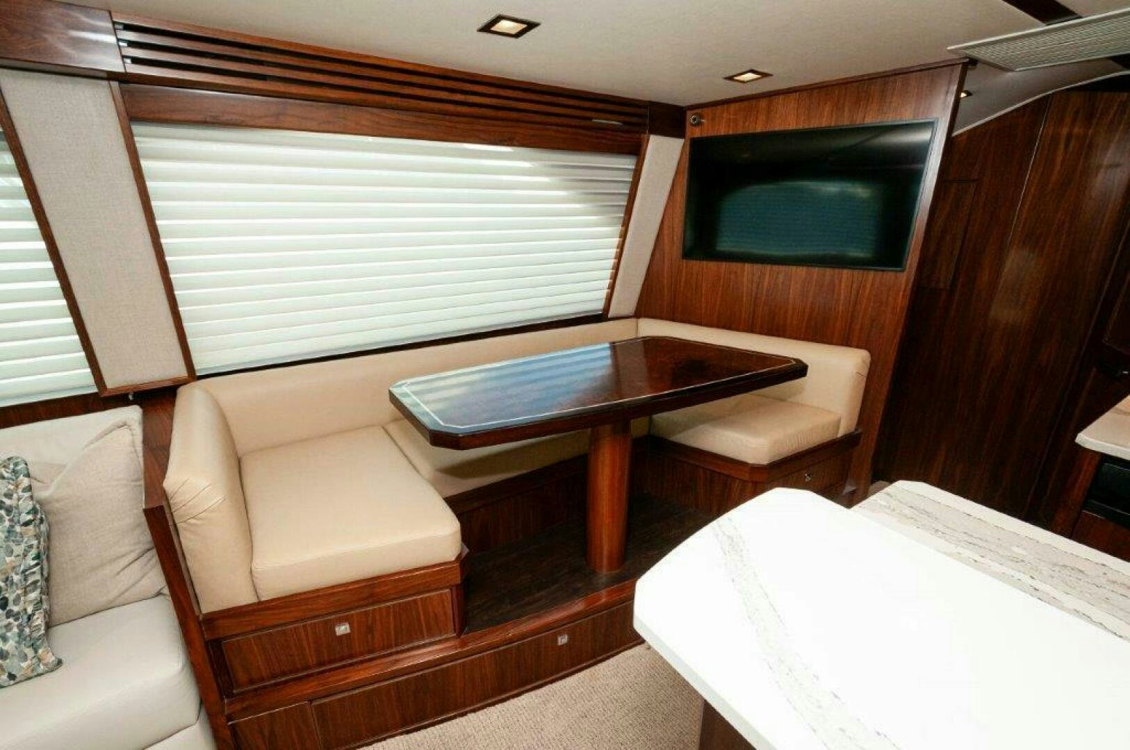 a room with a table and couch aboard FLEUR DE LIS Yacht for Sale