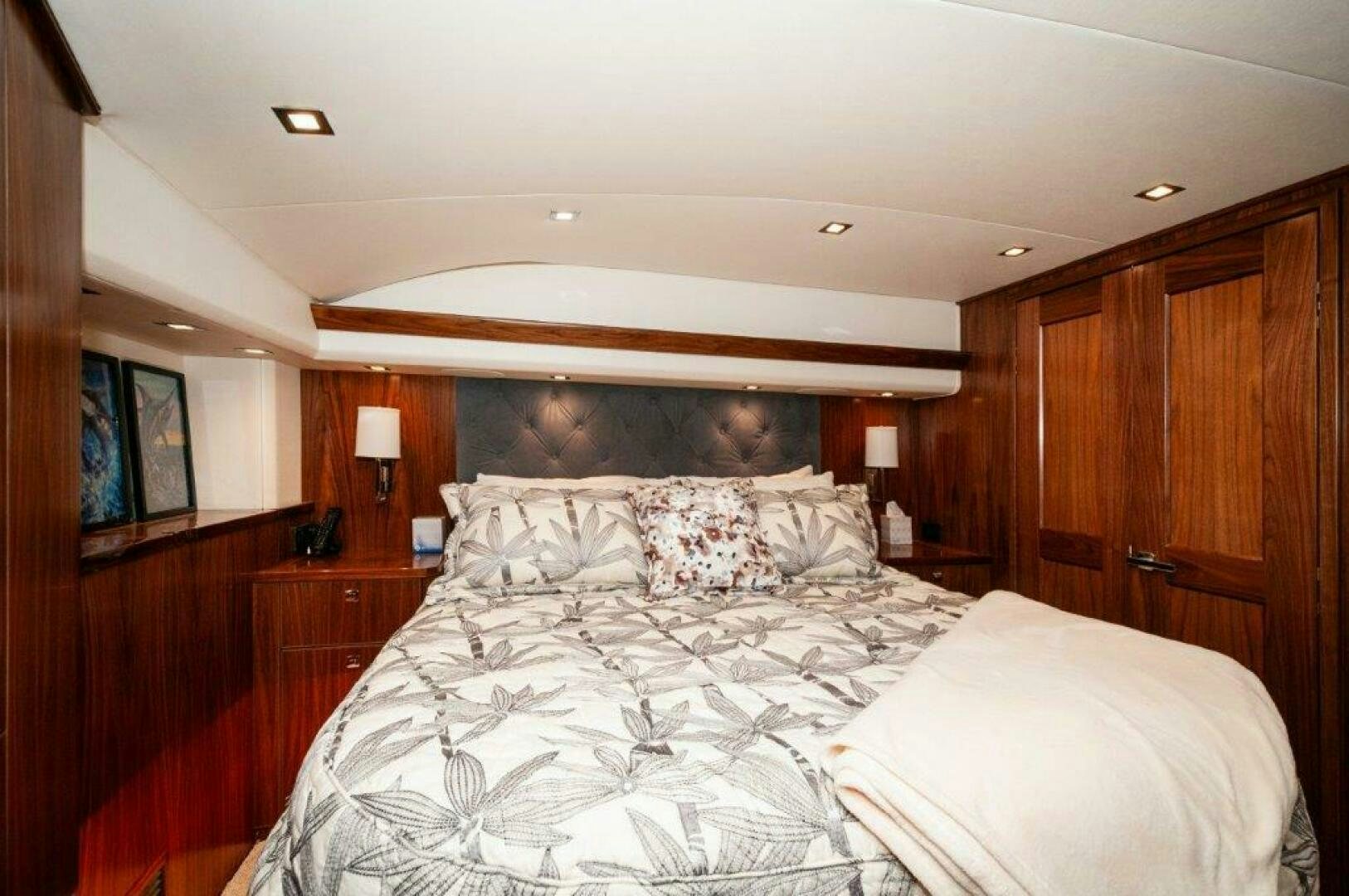 a room with a bed and a wood cabinet aboard FLEUR DE LIS Yacht for Sale