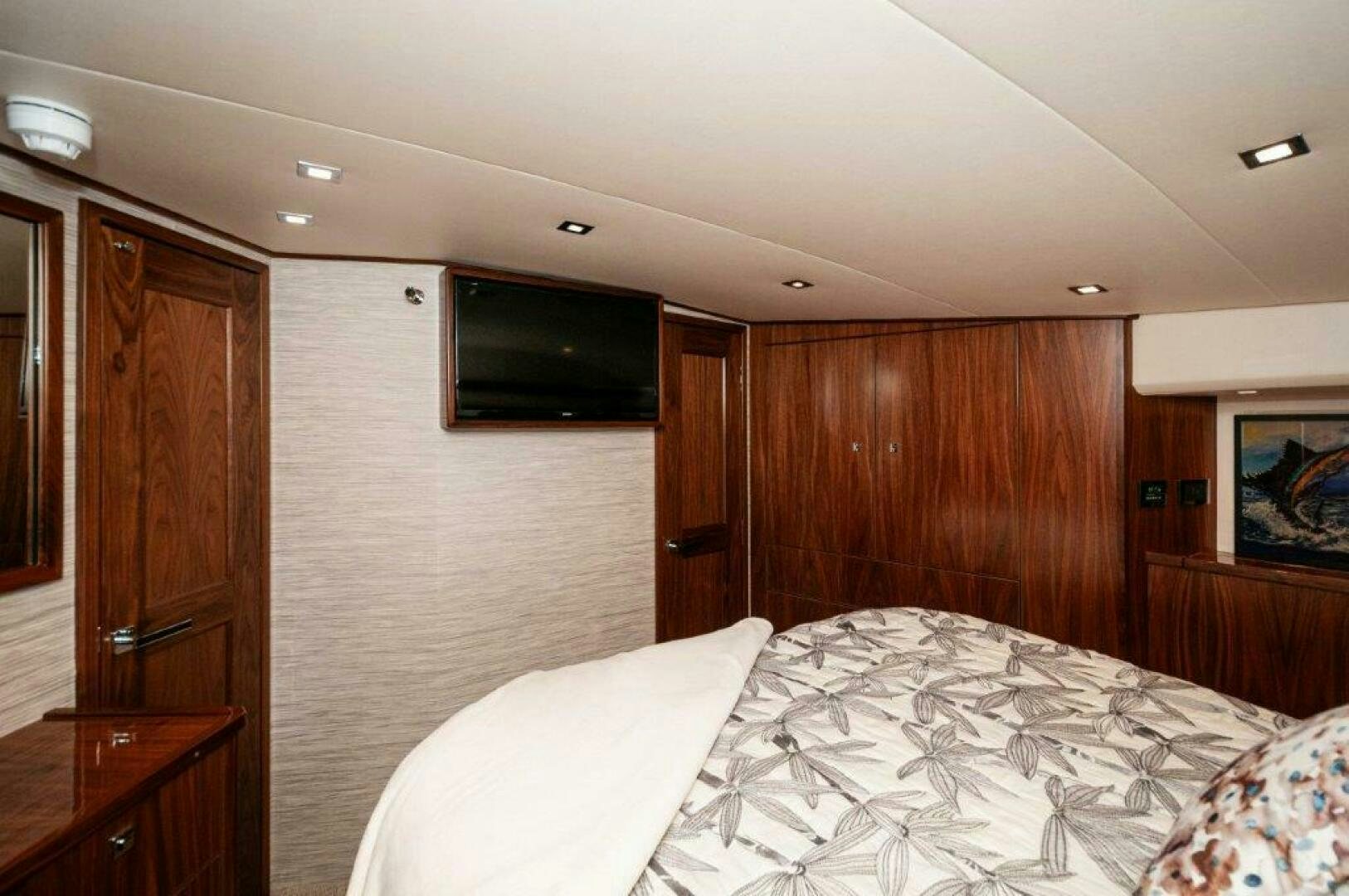 a bedroom with a bed and a television aboard FLEUR DE LIS Yacht for Sale