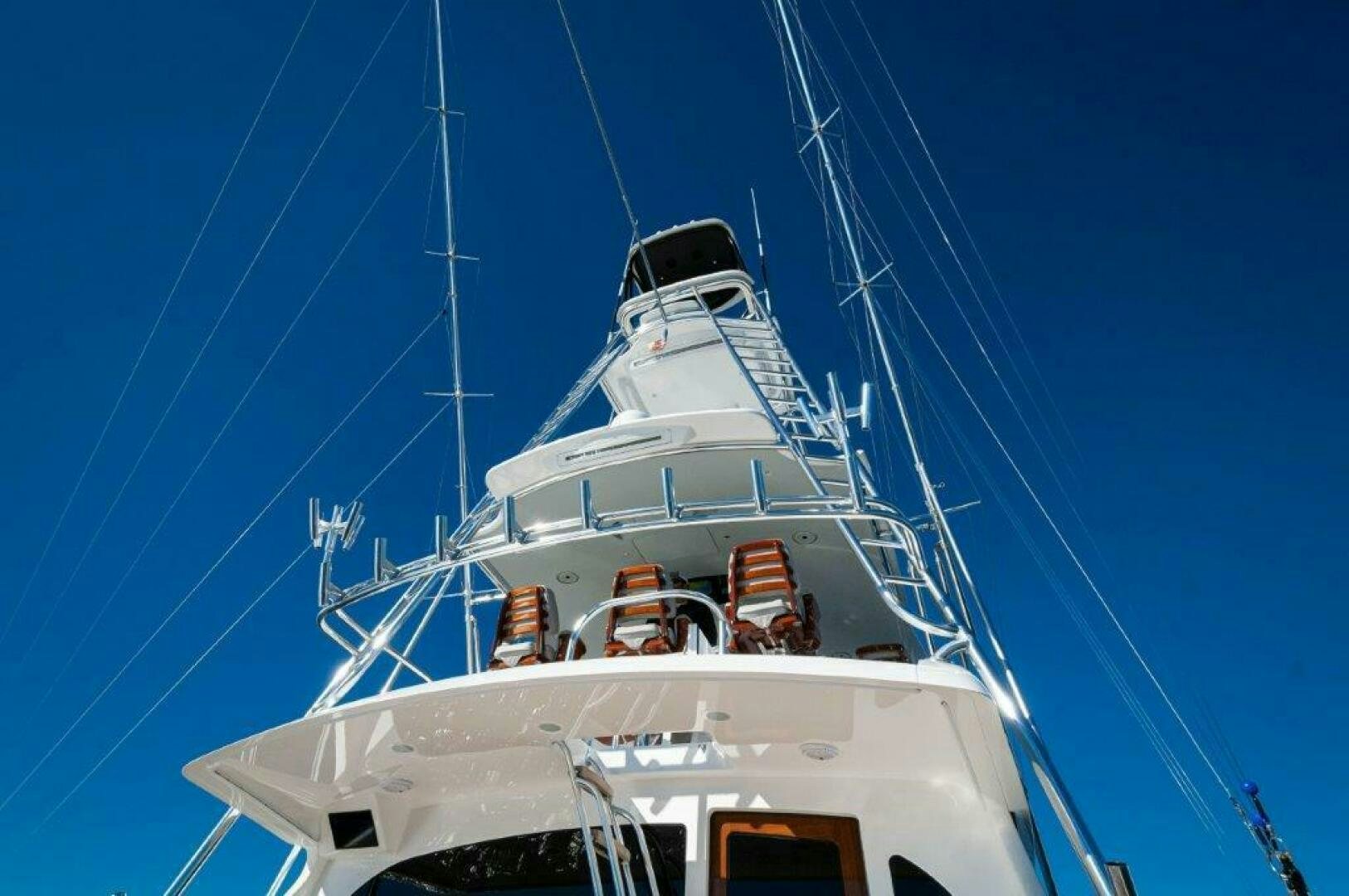 a white boat with a blue sky aboard FLEUR DE LIS Yacht for Sale