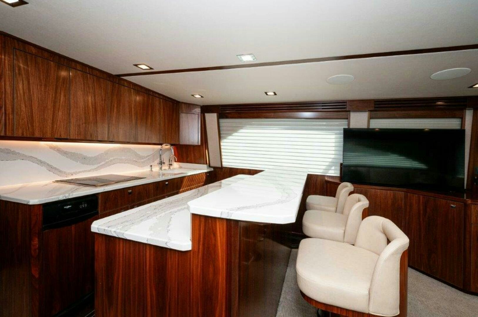 a room with a bed and a chair aboard FLEUR DE LIS Yacht for Sale