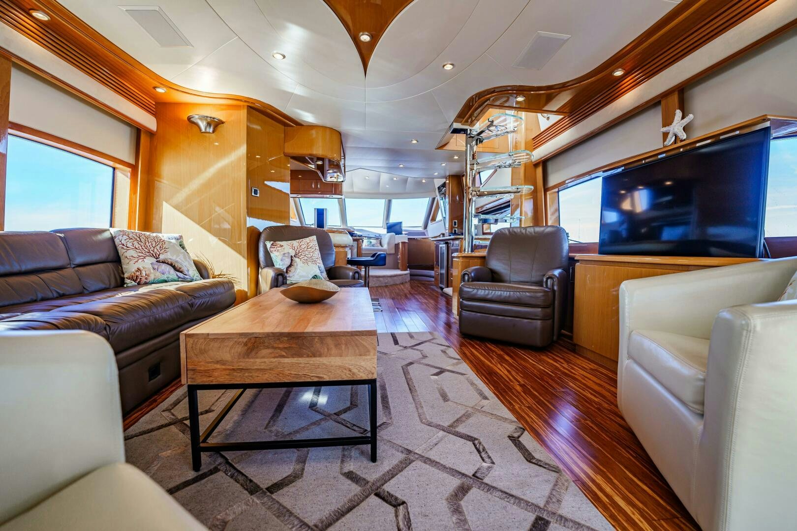 a living room with a wood table aboard SERENITY Yacht for Sale