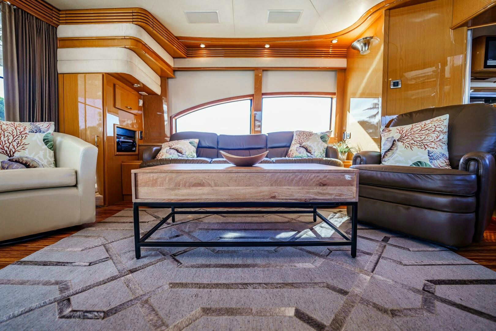 a living room with a couch and a table aboard SERENITY Yacht for Sale