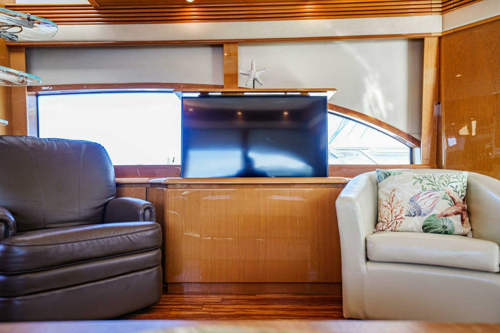 a living room with a couch and a tv aboard SERENITY Yacht for Sale