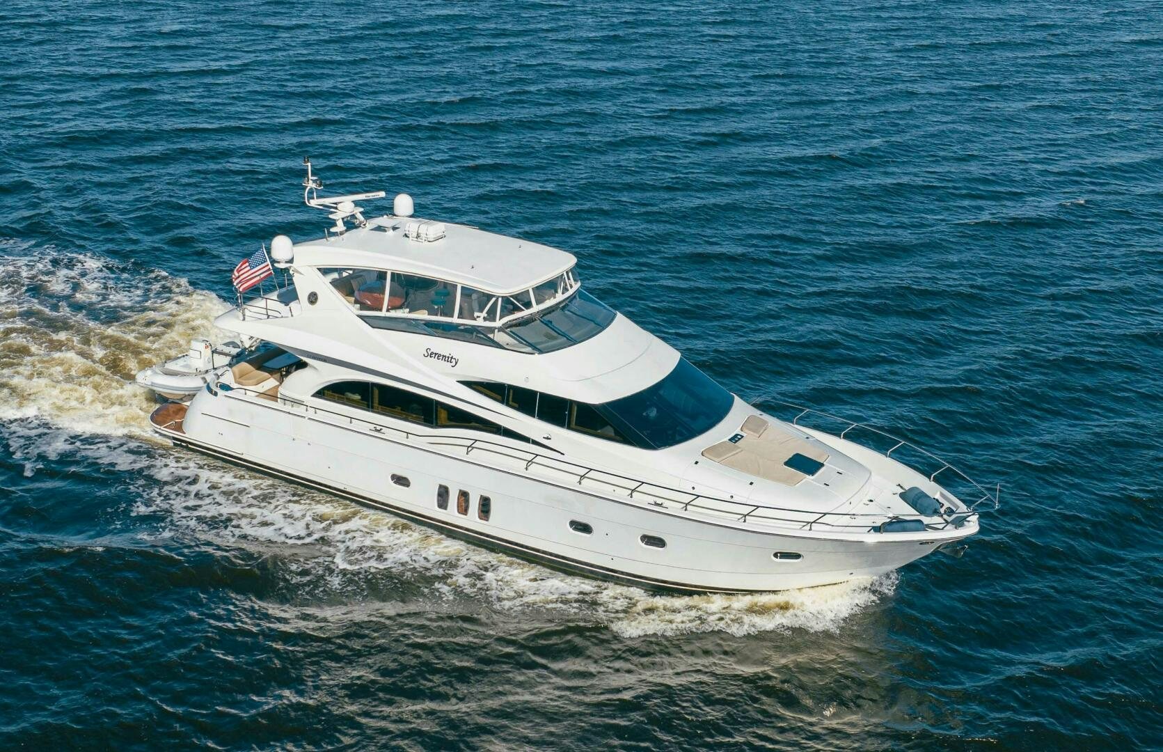 a white boat on the water aboard SERENITY Yacht for Sale