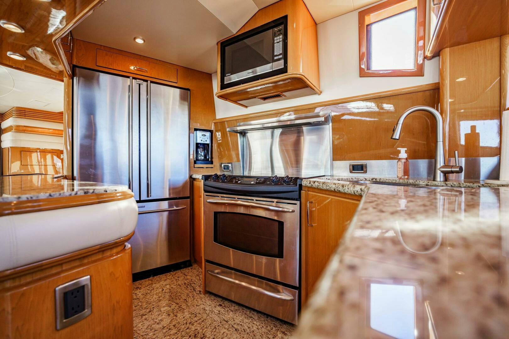 a kitchen with a stove and microwave aboard SERENITY Yacht for Sale