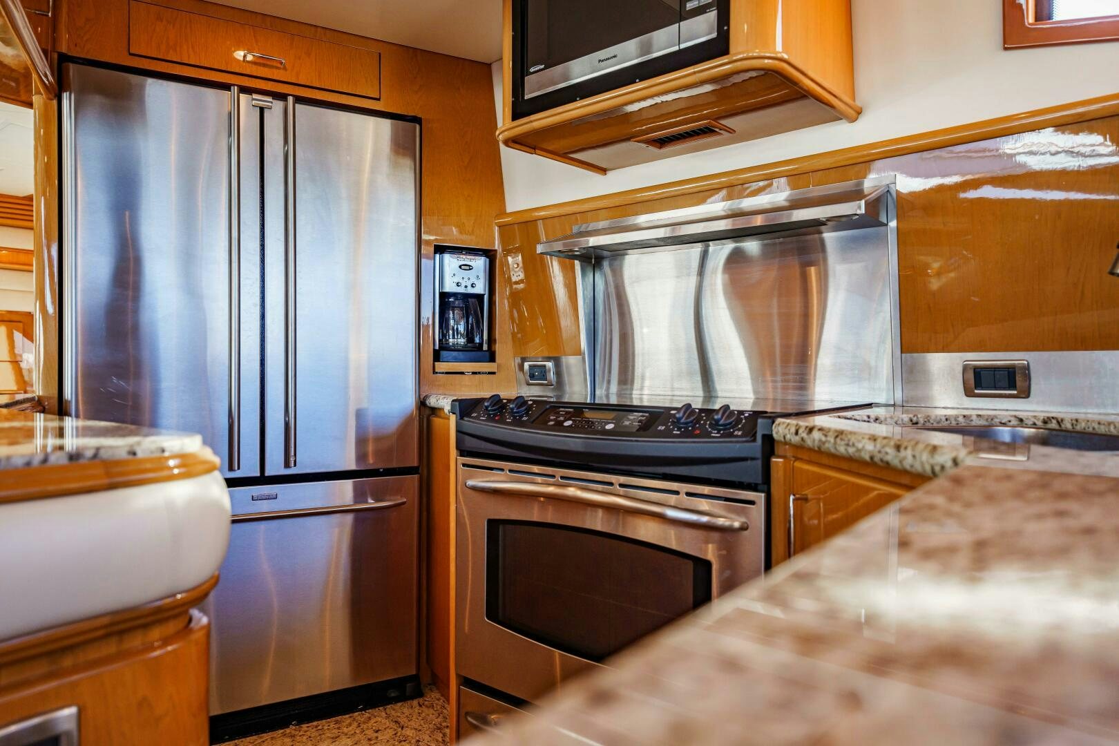 a kitchen with stainless steel appliances aboard SERENITY Yacht for Sale