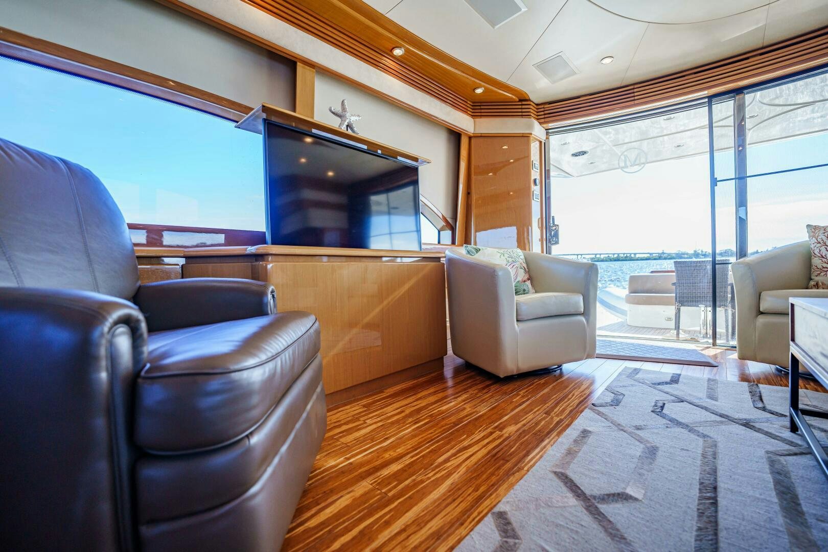 a living room with leather furniture aboard SERENITY Yacht for Sale